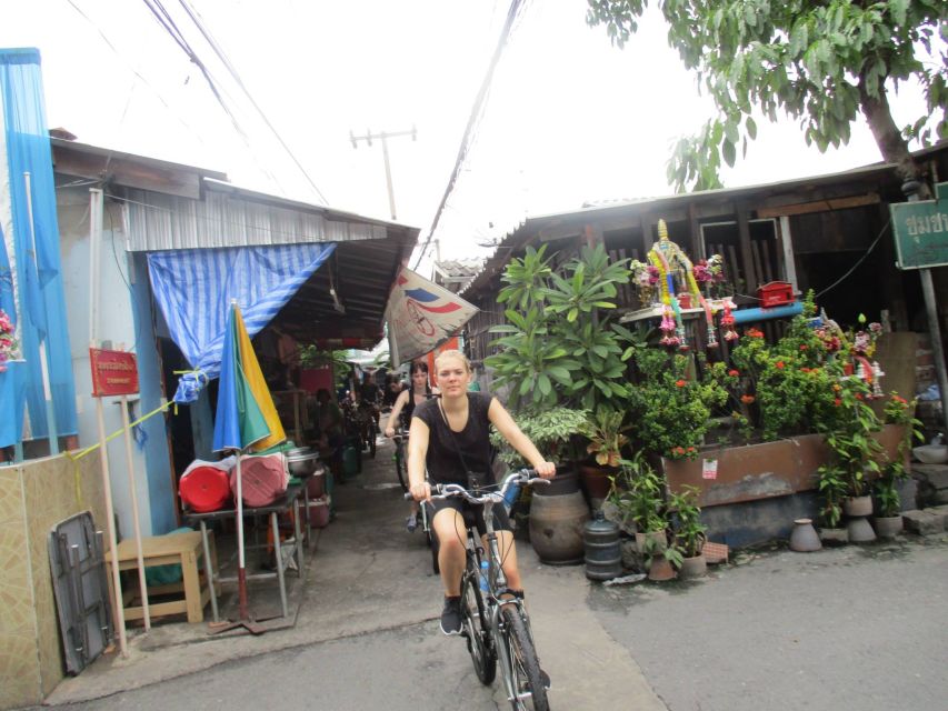 Bangkok Full-Day Bike Tour with Boat Transfer and Lunch - Plantations, raised paths, and monitor lizards
