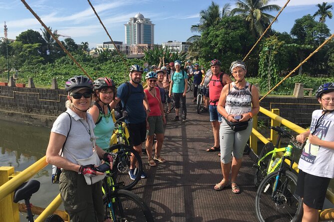 Half-Day Heritage Bike Tour in Kuching - Following the river toward a Malay kampong
