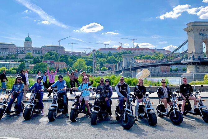 Monster Bike Sightseeing Tour – City Budapest on Electric Rollers - Shoes on the Danube Bank and the Parliament view