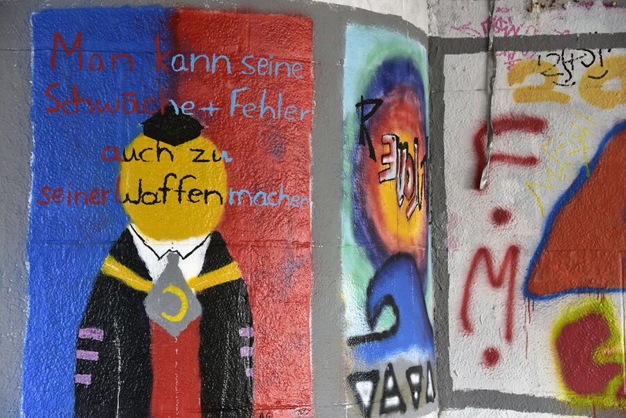 Munich: Street Art Bike Tour - A break on a boat beneath a railway bridge