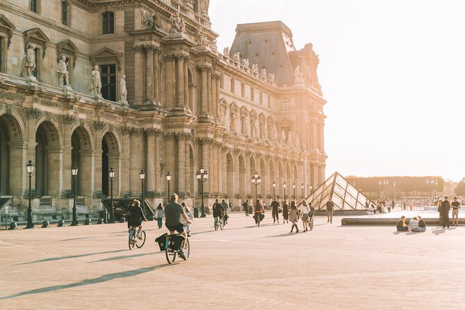 Paris Evening City of Lights Small Group Bike Tour & Boat Cruise - Riding from the Louvre toward the Seine